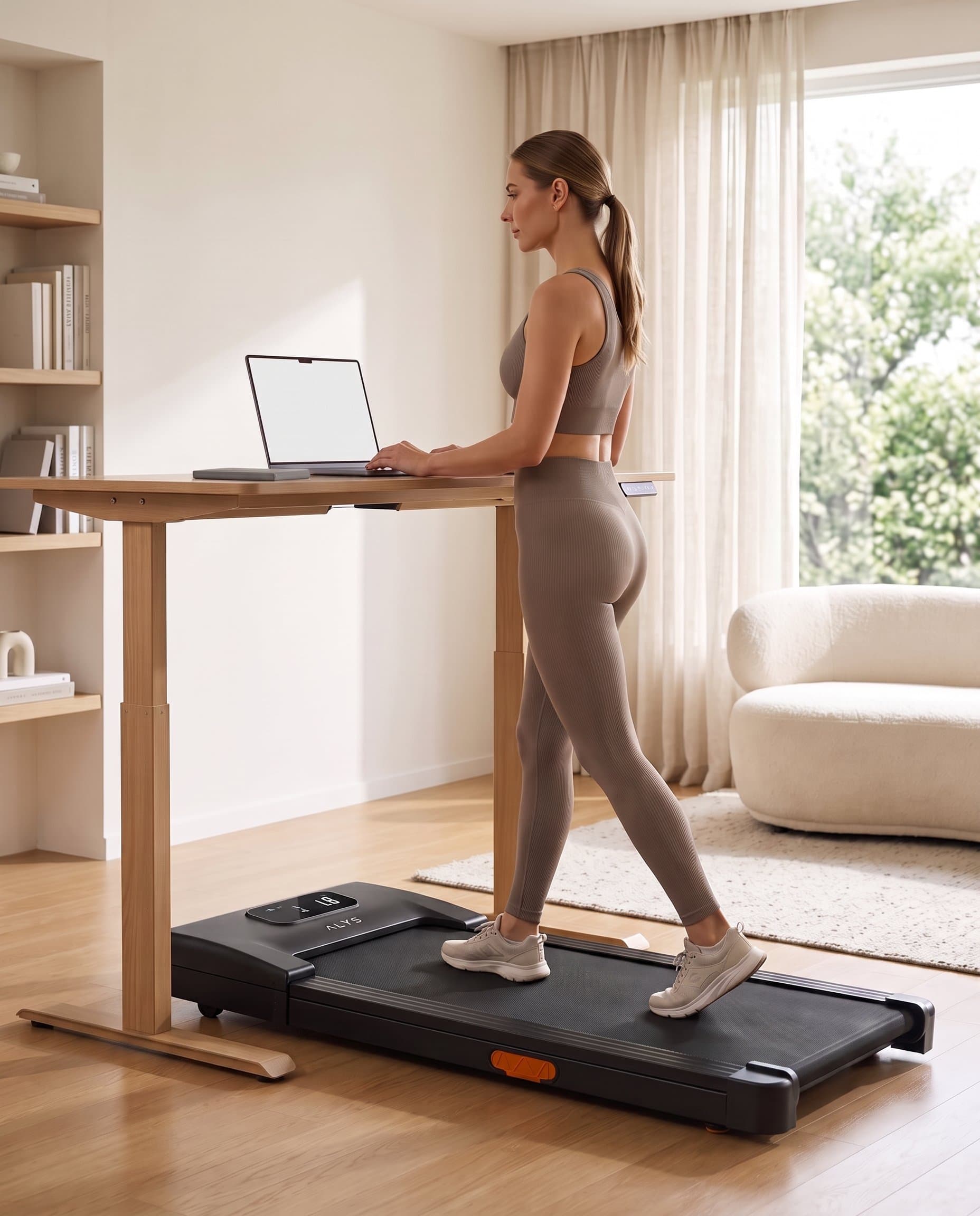 Walking at standing desk on ALYS STRIDE, laptop open
